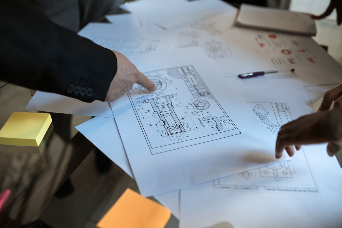 Drafting team reviewing technical plans