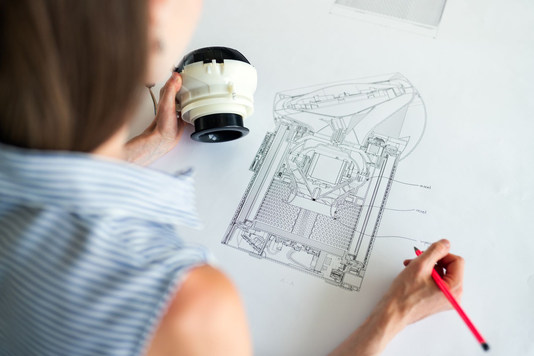 Detailed technical drawing being reviewed at a CAD drafting workspace